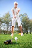 foto of golf  - Young handsome man playing golf - JPG 