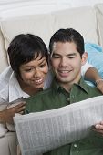 image of newspaper  - Hispanic couple reading newspaper - JPG 