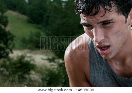 Picture or Photo of Young athletic man taking a break during a challenging jogging outdoor