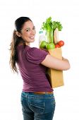 stock photo of food  - Young woman holding a grocery bag full of fresh and healthy food isolated on white background - JPG 