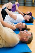 image of fitness  - Happy fitness people in a row doing some aerobic stretching after workout at gym - JPG 