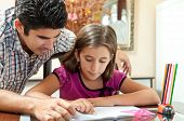 stock photo of home  - Young father helping her daughter with her school project at home - JPG 