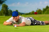 image of golf  - Young golf player on course putting - JPG 