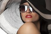 image of hat  - Portrait of beautiful model in striped hat with glasses - JPG 