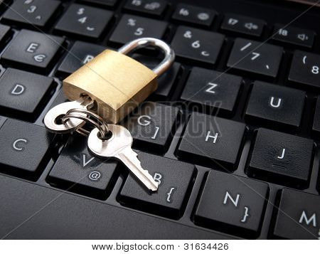 Picture or Photo of Keys and padlock on the computer keyboard as a data security concept.