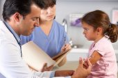 stock photo of md  - Doctor Giving Child Injection In Doctor - JPG 