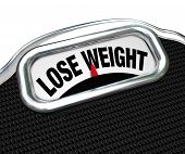 picture of health  - The words Lose Weight on the display of a scale to tell you you need to go on a diet to drop pounds and trim fat to improve your health - JPG 