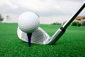 foto of golf  - Golfer getting ready to tee off on the tee greens - JPG 