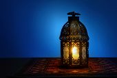 foto of religion  - An illuminated Arabic lantern on blue background - JPG 