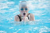 pic of health  - Happy muscular swimming woman  wearing glasses and cap at swim pool and represent health and fit concept - JPG 