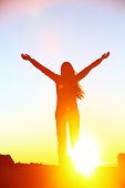 image of sunset  - Happy cheering celebrating success woman at beautiful sunset above the clouds - JPG 