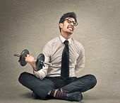 stock photo of businessmen  - young businessman tries to lift a weight - JPG 