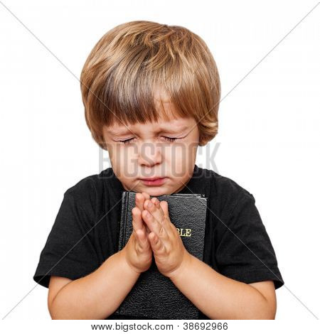 Picture or Photo of Little boy praying with the Bible in hand