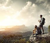 foto of group  - Hikers with backpacks enjoying valley view from top of a mountain - JPG 