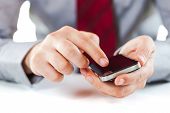 pic of internet  - close up of a business man using a mobile phone - JPG 