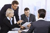 stock photo of business people  - Businesspeople working together at meeting table in office - JPG 