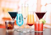 pic of difference  - Several glasses of different drinks on bright background - JPG 
