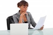 picture of reading  - Woman carefully reading through document - JPG 