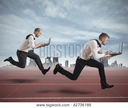 Picture or Photo of Conceot of competition with two running businessman in a track