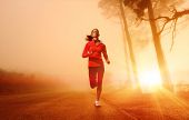 pic of fitness  - Athlete running on the road in morning sunrise training for marathon and fitness - JPG 