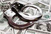 foto of security  - Handcuffs on money background as security concept - JPG 