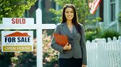 image of agent  - A female real estate agents smiles at the camera outside - JPG 