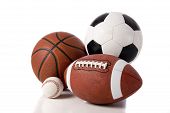 picture of sports  - A group of sports balls on a white background including a baseball an American football a basketball and a soocer ball - JPG 
