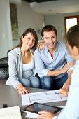 stock photo of future  - Couple meeting architect for plans of future home - JPG 