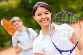 foto of play  - Female tennis player at the court playing doubles - JPG 