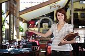 stock photo of business  - small business: proud female owner of a restaurant with copy space
** Note: Slight blurriness, best at smaller sizes - JPG 