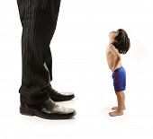 image of leadership  - Little small child  is looking at the giant legs of  businessman adult - JPG 