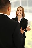 picture of business people  - two business people discussing in office environment - JPG 