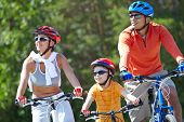 foto of family  - Portrait of happy family riding on bicycles at leisure - JPG 