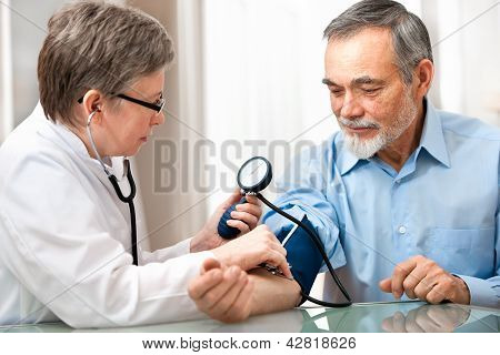 Picture or Photo of Doctor measuring blood pressure of male patient