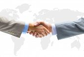 picture of handshake  - Handshake with map of the world in background - JPG 
