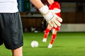 picture of man  - Man scoring a goal at indoor football or indoor soccer - JPG 