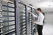 stock photo of industrial  - young handsome business man  engeneer in datacenter server room - JPG 