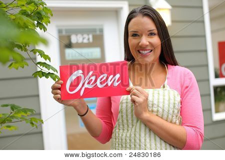 Picture or Photo of Small Business owner with "open" sign