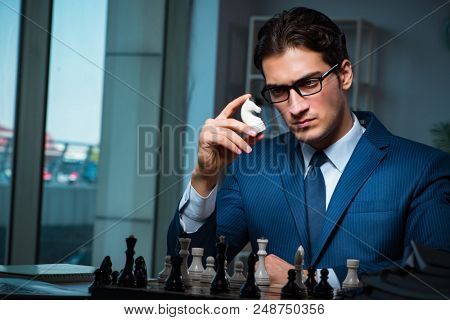 Poster: Businessman playing chess in strategy