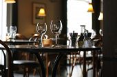 stock photo of restaurant  - Interior of a cozy restaurant focusing on a ready table for two - JPG 