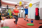 stock photo of fitness  - Crossfit fitness gym weight lifting bar by woman and man group workout - JPG 
