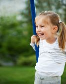 image of teeter  - Pretty little girl on outdoor seesaw - JPG 