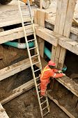 stock photo of construction worker  - underground maintenace work on municipal water mains - JPG 