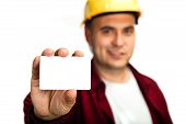 picture of construction  - Construction worker holding a blank business card business introduction concept - JPG 