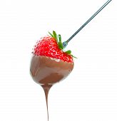 stock photo of drip  - A sweet ripe strawberry dripping with warm milk chocolate - JPG 
