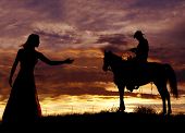 pic of horse  - A cowboy is sitting on a horse in the sunset swinging a rope - JPG 