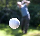 image of golf  - A golf ball just coming off the tee from a golfer in swing - JPG 