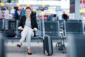 stock photo of wait  - Young female passenger at the airport - JPG 