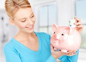 image of money  - picture of lovely woman with piggy bank and money - JPG 