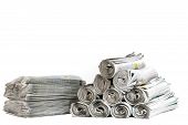 stock photo of newspaper  - A selection of newspapers rolled up and in a pile - JPG 